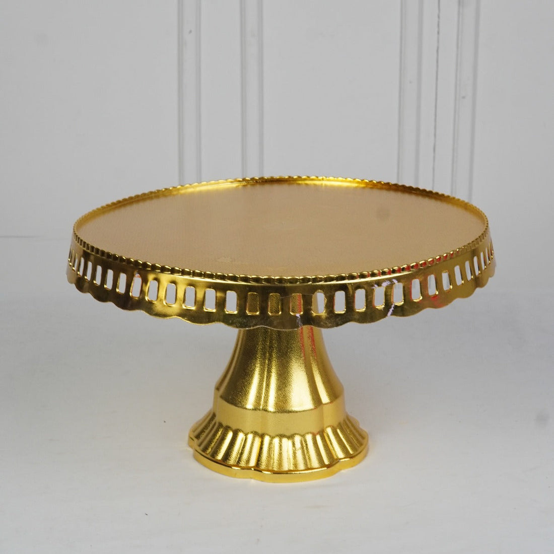 Gold cake stand on a white background