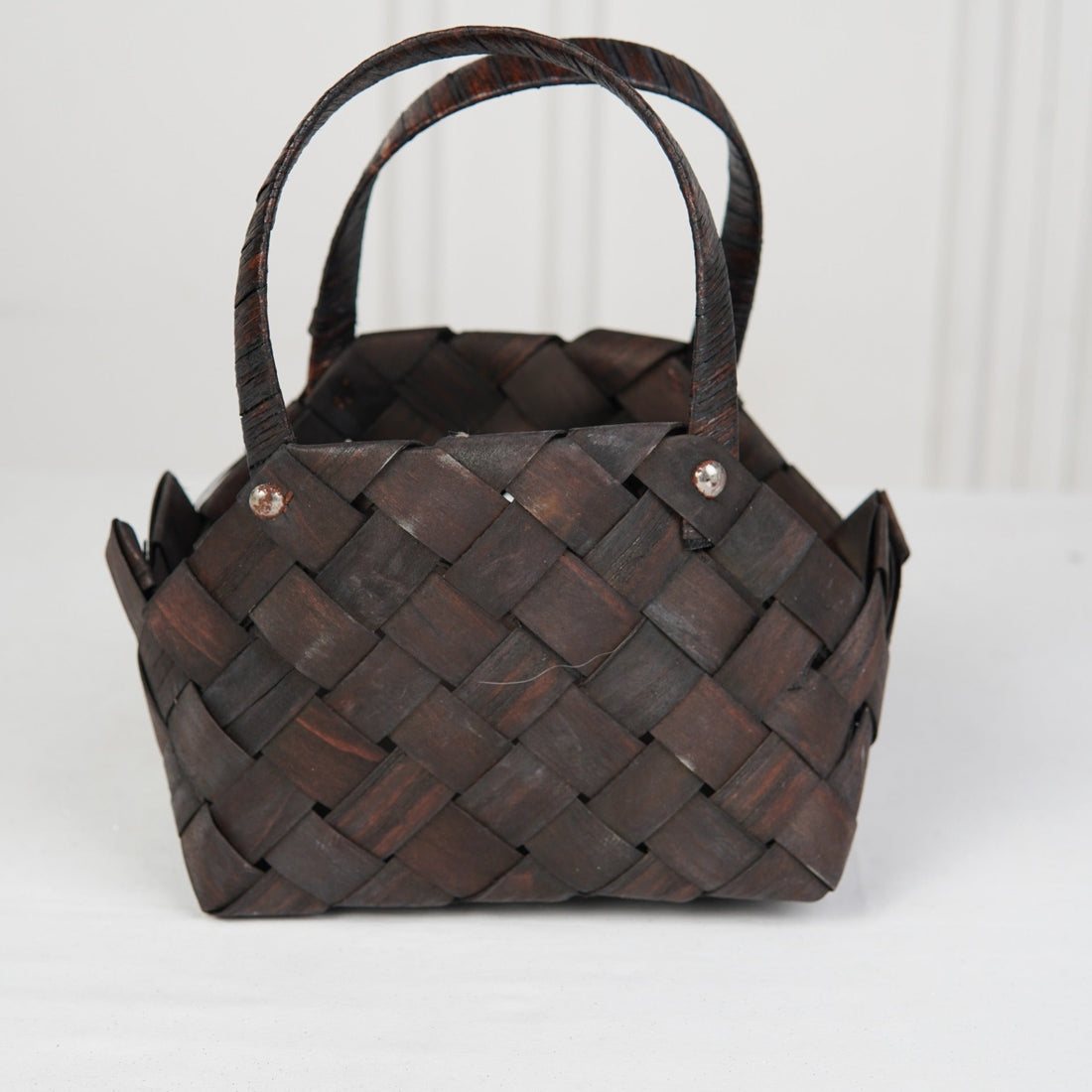 Woven brown handbag on a white background